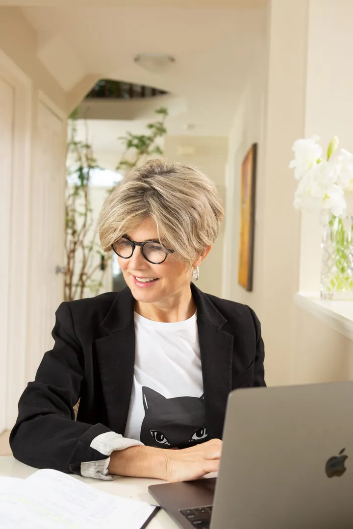 Catherine Harrison working at a laptop